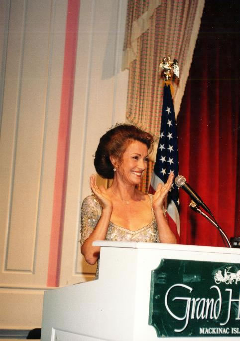 Jane at podium applauding during Somewhere in time weekend