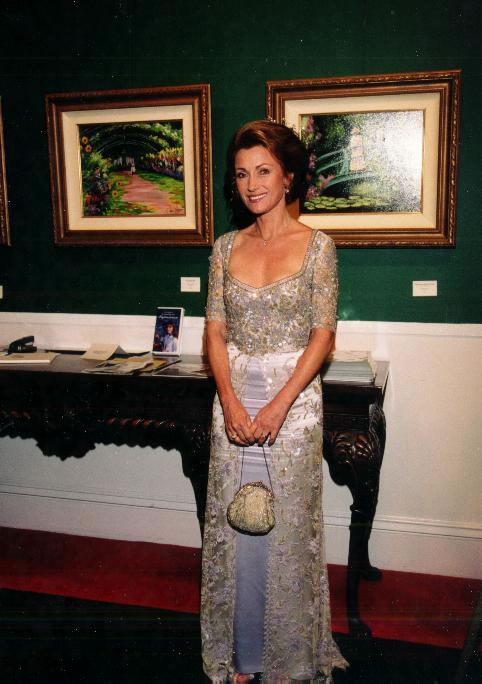 Jane Seymour poses at the Grand Hotel before two of her paintings