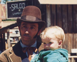 Frank Collison poses with toddler on set of Dr. Quinn