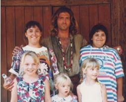 Joe lando poses with children on the set of Dr Quinn